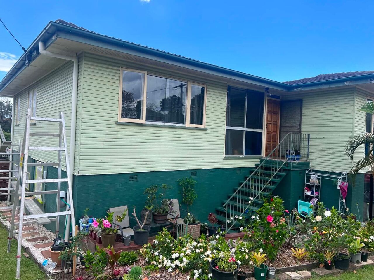 Repainted two-tone weatherboard Queenslander in Brisbane